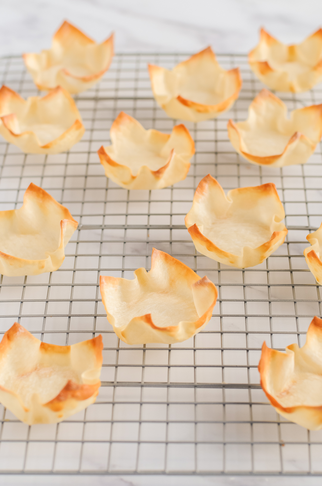 Baked Wonton Cups on a Cooling Rack.