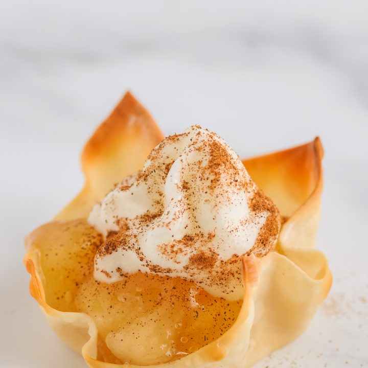 Whipped Topping on top of apple pie wontons.