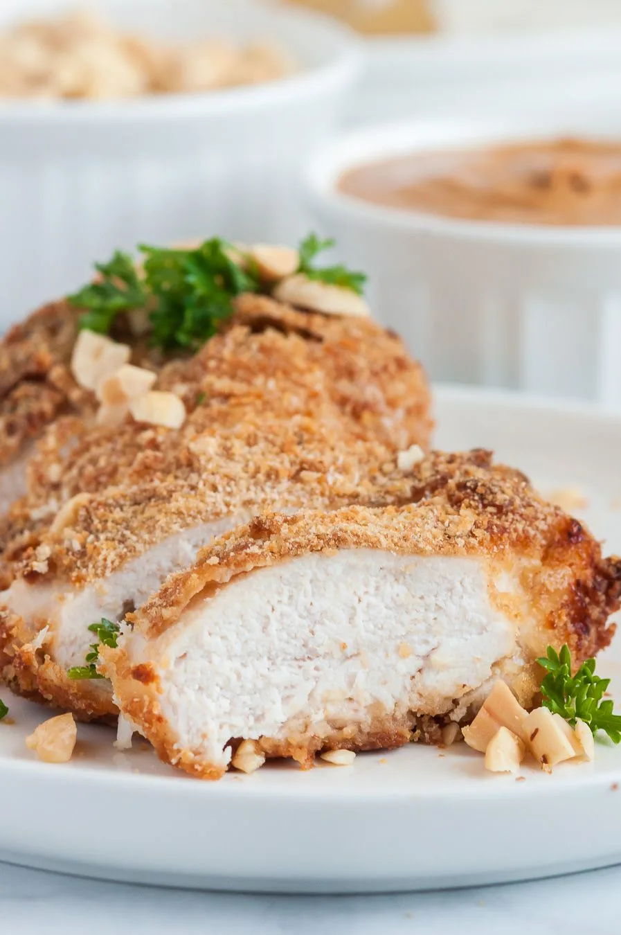 close up of coated and baked chicken breast