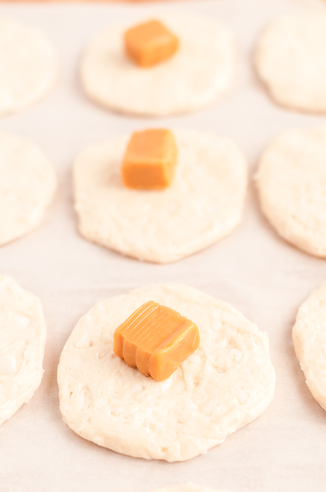 placing caramel into biscuit dough