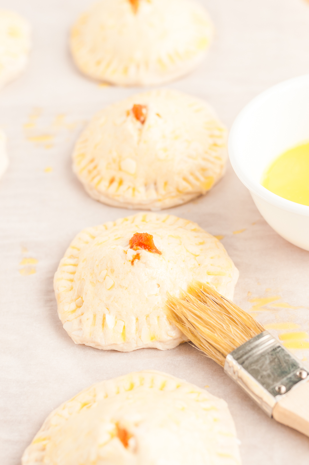 adding egg wash to mini pies