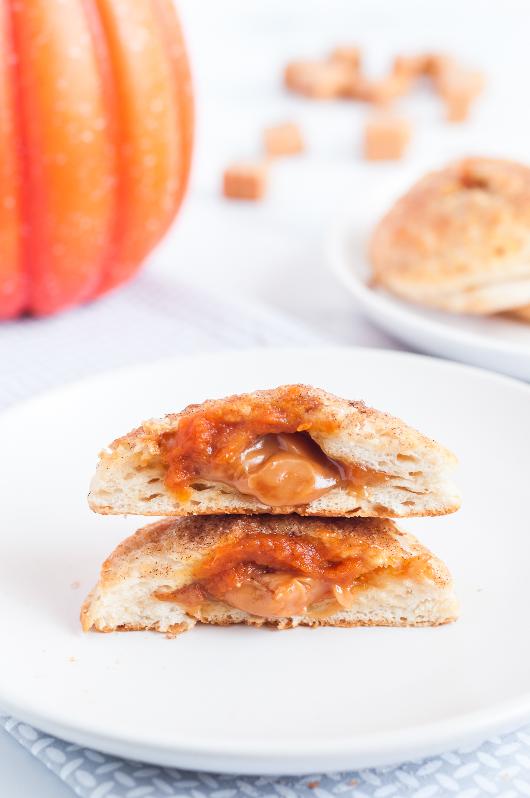 caramel and pumpkin pie filling oozing out of mini pies