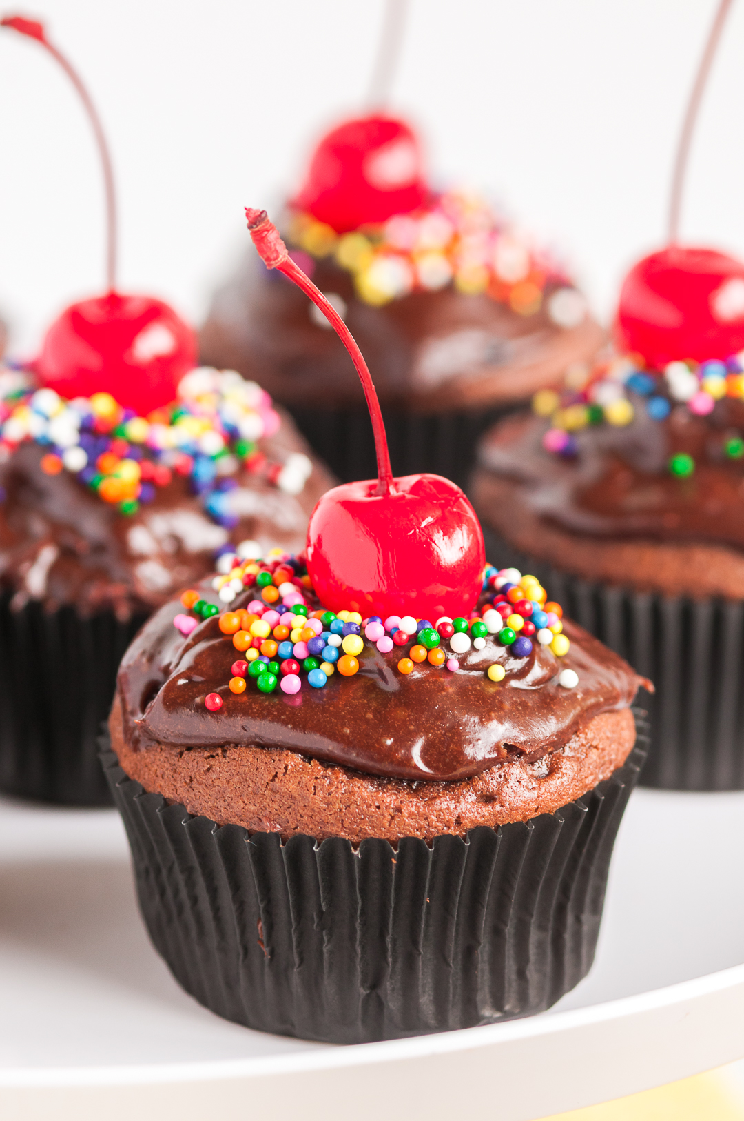 cherry topped cupcakes up close