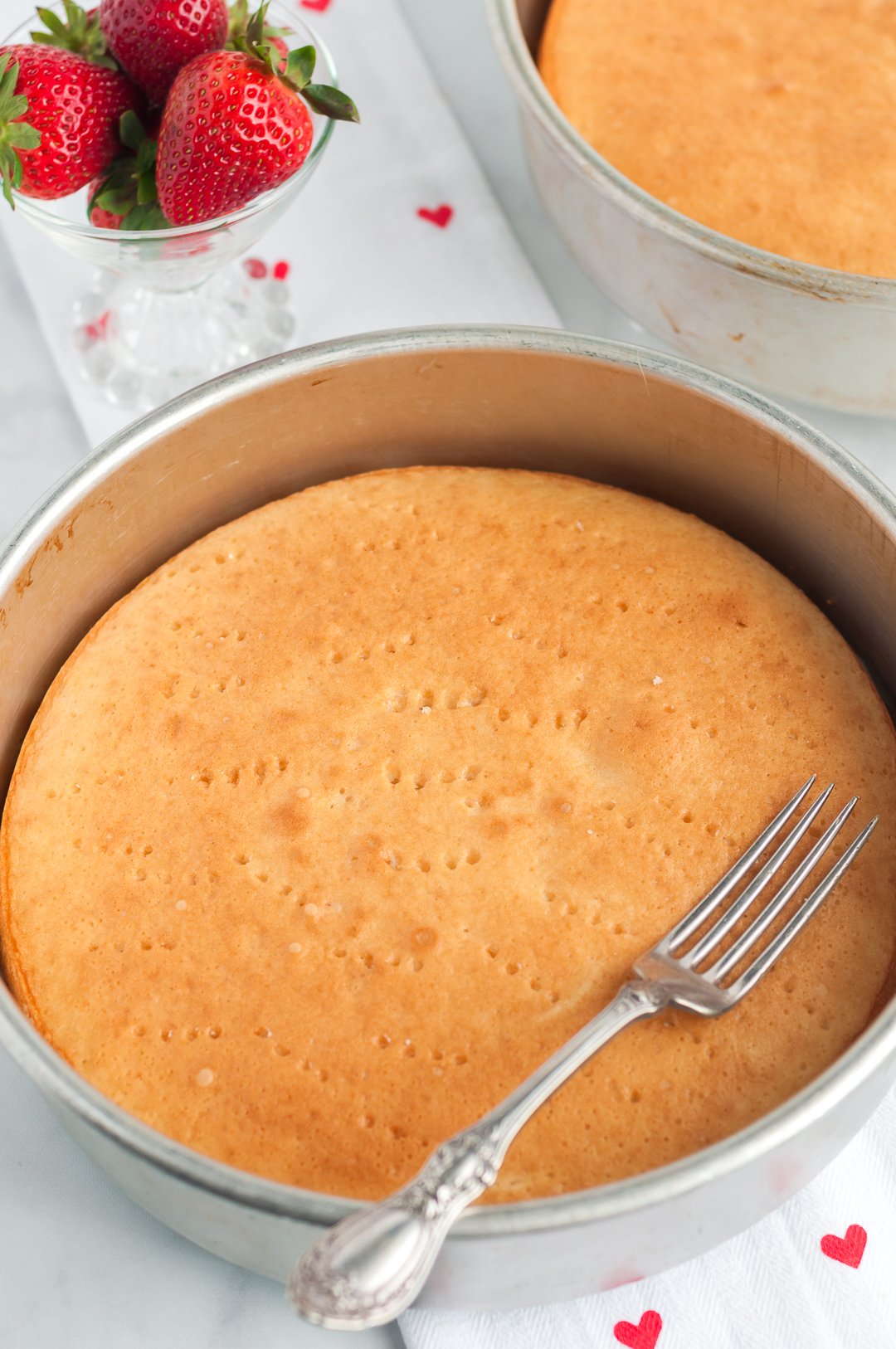 cake poked with a fork to prepare for making a poke cake