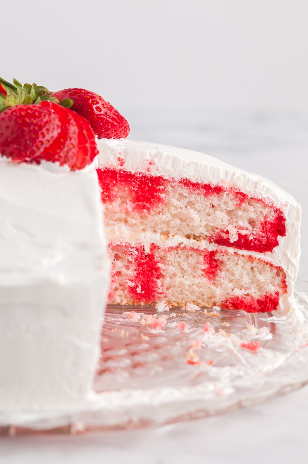 sliced poke cake with a look at the inside layers