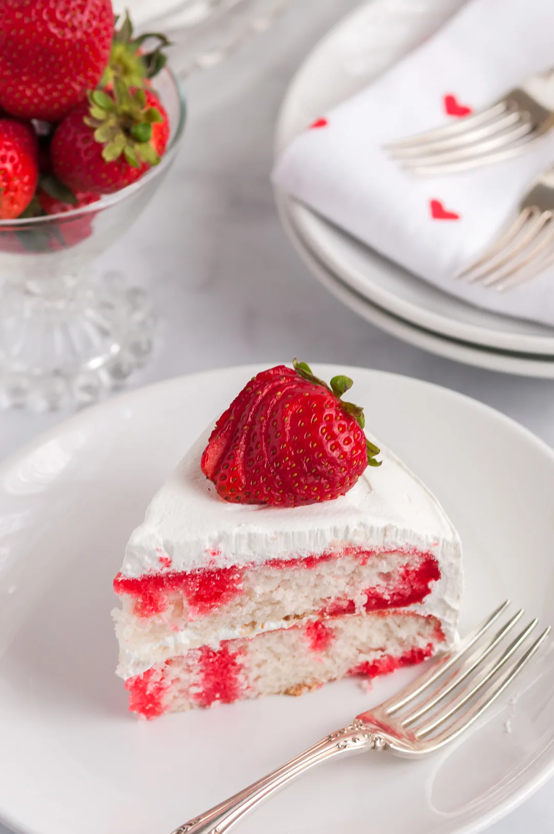plated slice of strawberry poke cake