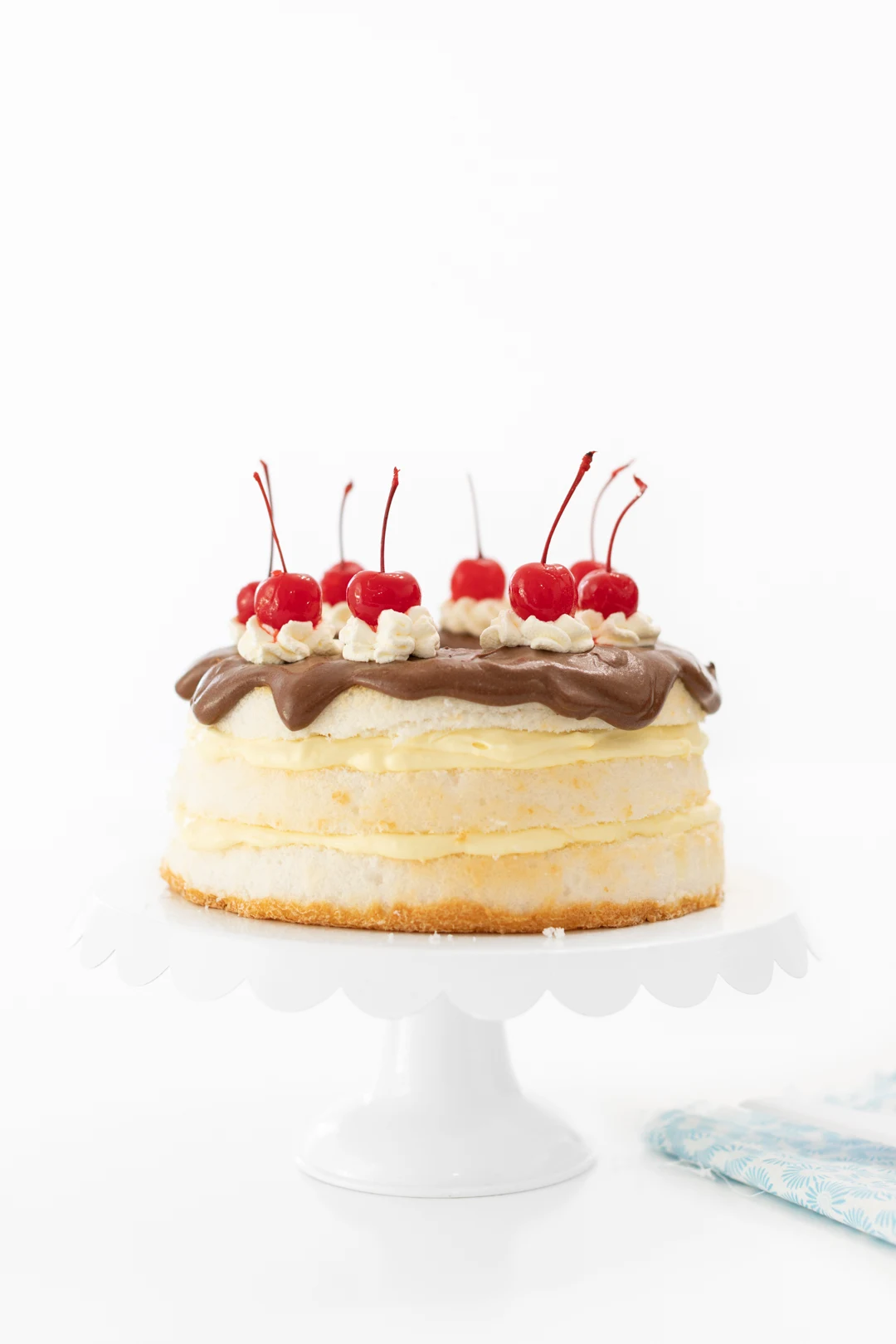 Boston Cream Pie That is Easy To Make. Topped with Cherries.