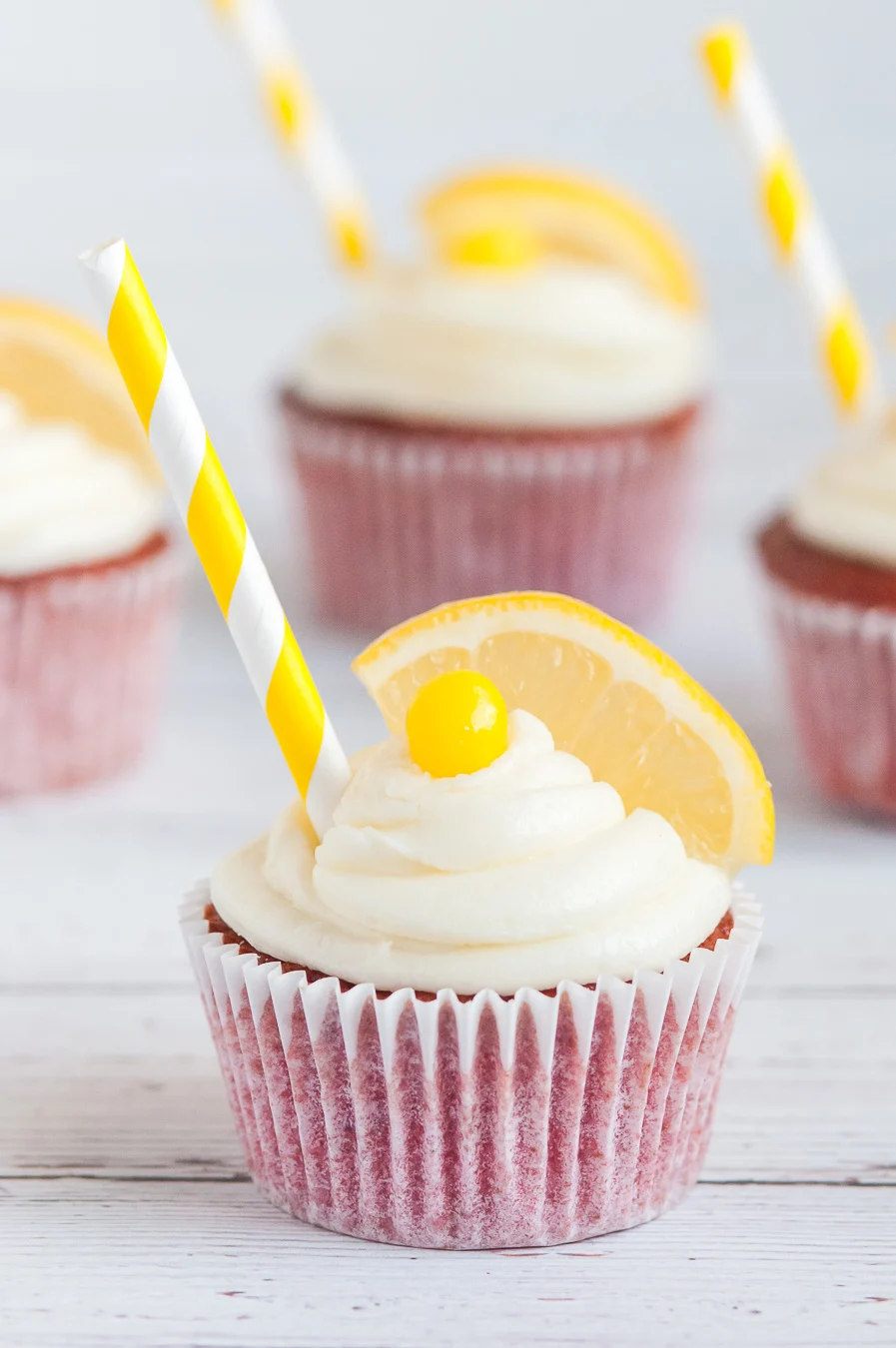 strawberry lemonade cupcakes with lemon wedge on top