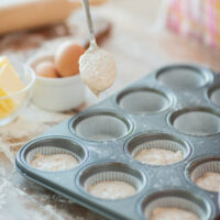 adding batter to muffin tins