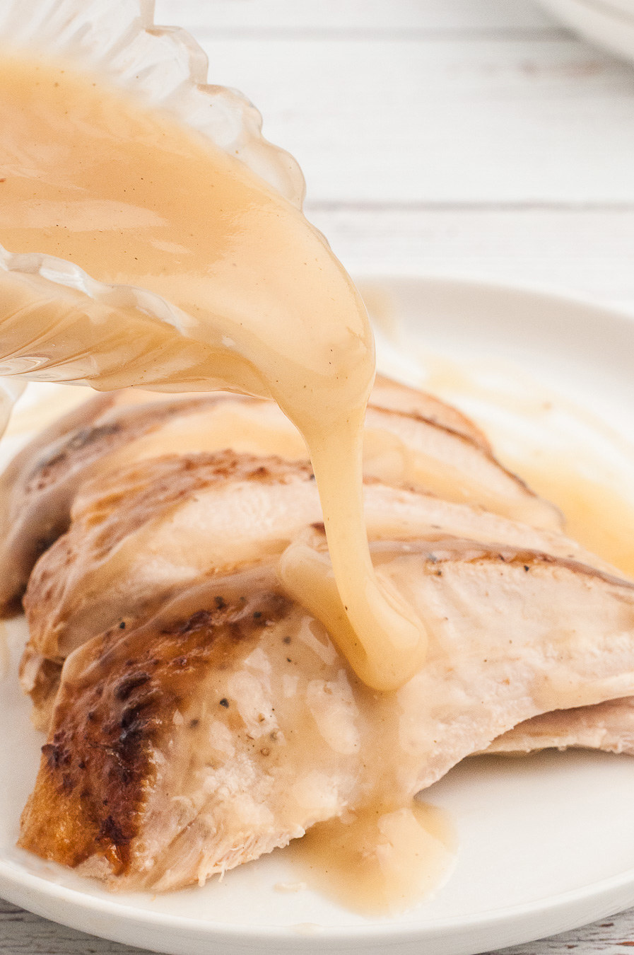 turkey slices with gravy being poured over it