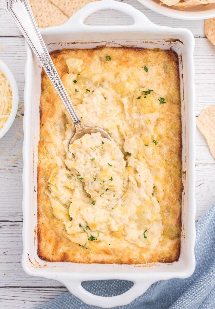 up close view of baked dip in a white baking dish