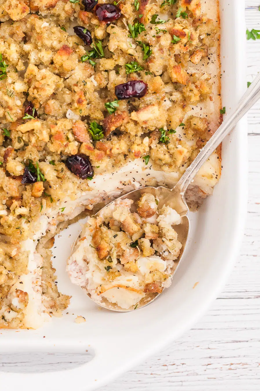 leftover turkey casserole being spooned out of casserole dish