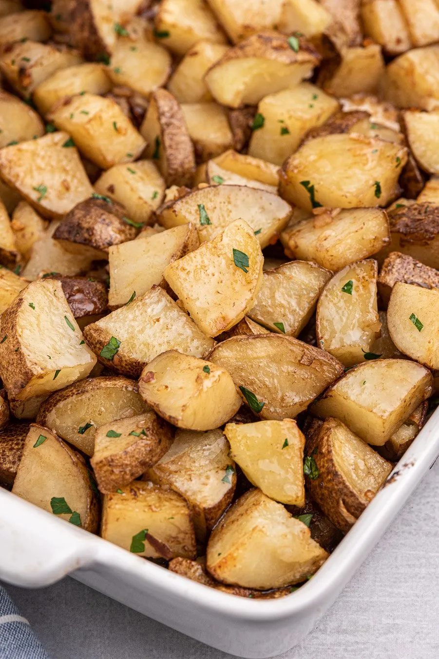 angled down view of baking dish full of roasted potatoes