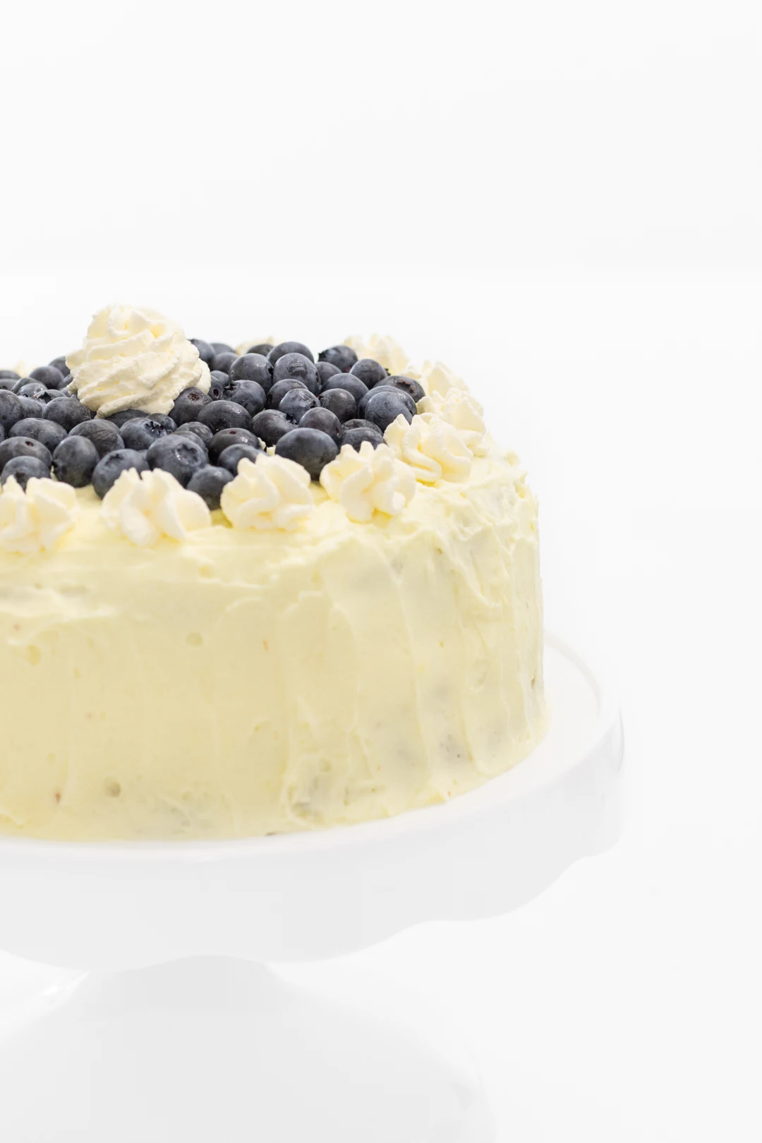 Simple lemon frosted cake with fresh blueberries.