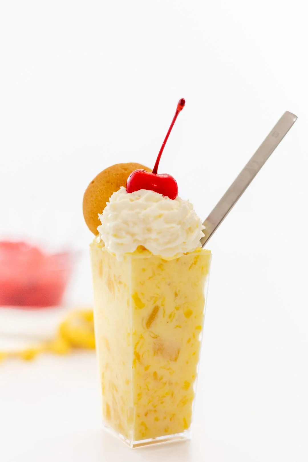 Pineapple Pudding with Whipped Cream, Nilla Wafer and Cherry Garnish.