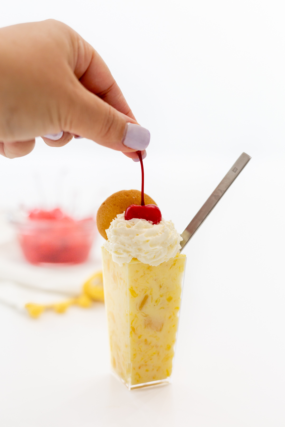 Adding a cherry to pineapple pudding