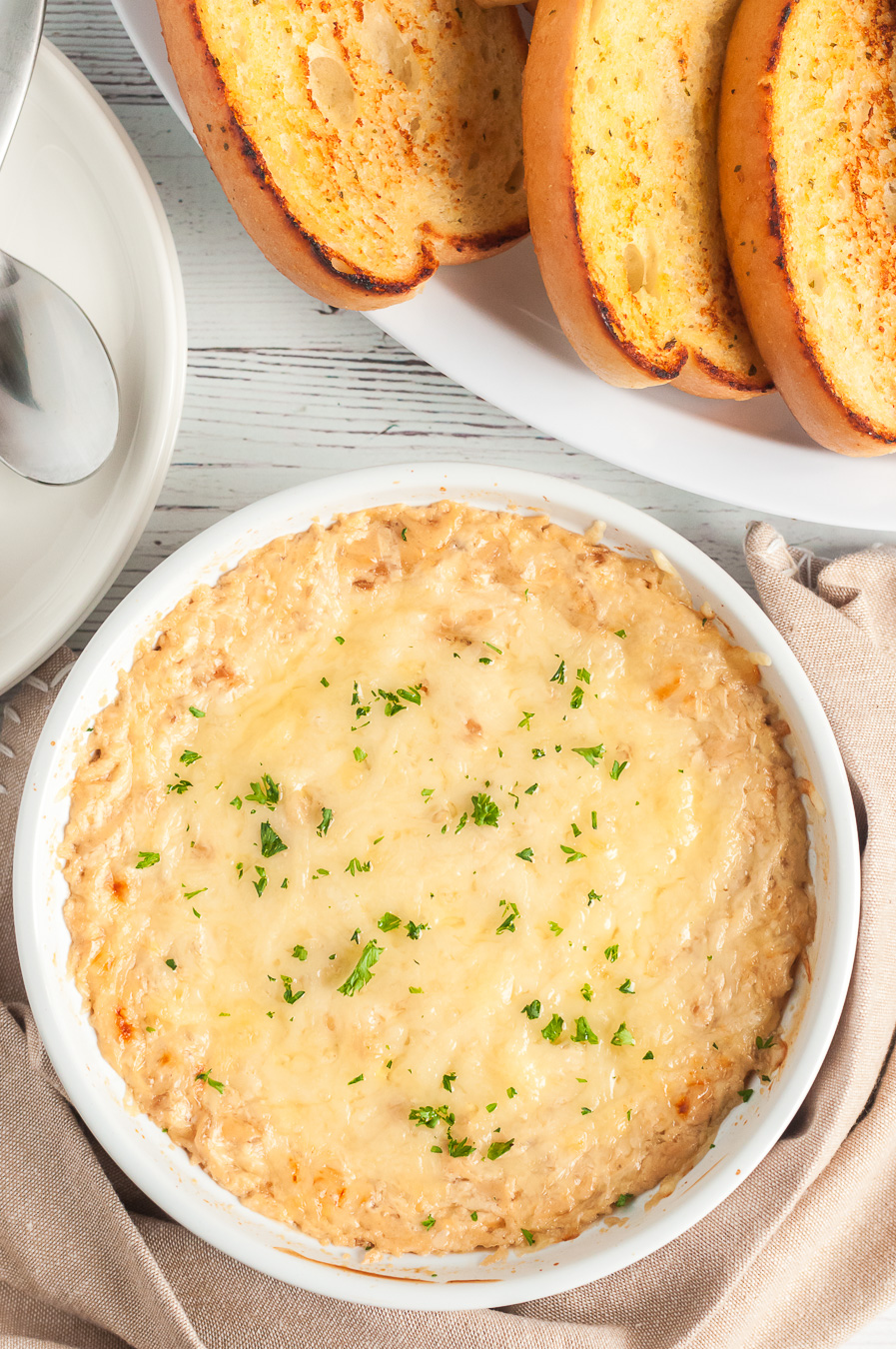 warm dip in serving dish with toasted garlic bread