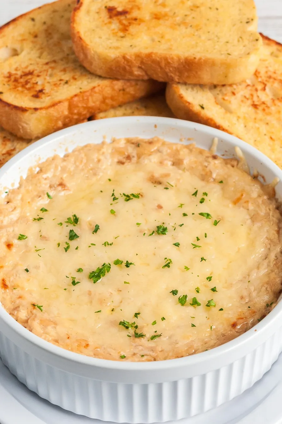 warm french onion dip up close with herbs