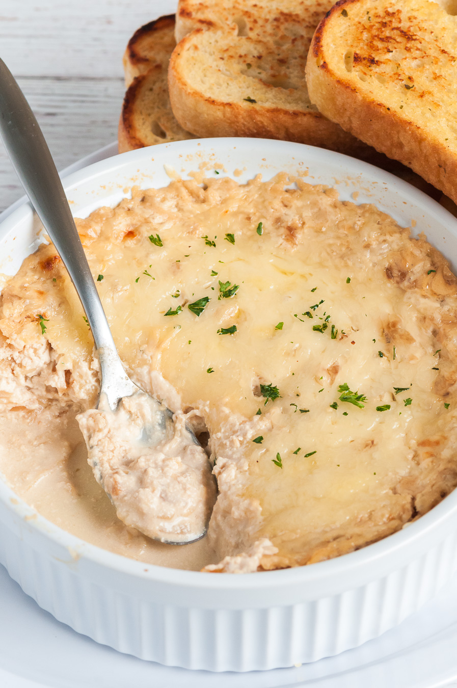 warm dip being served with spoon