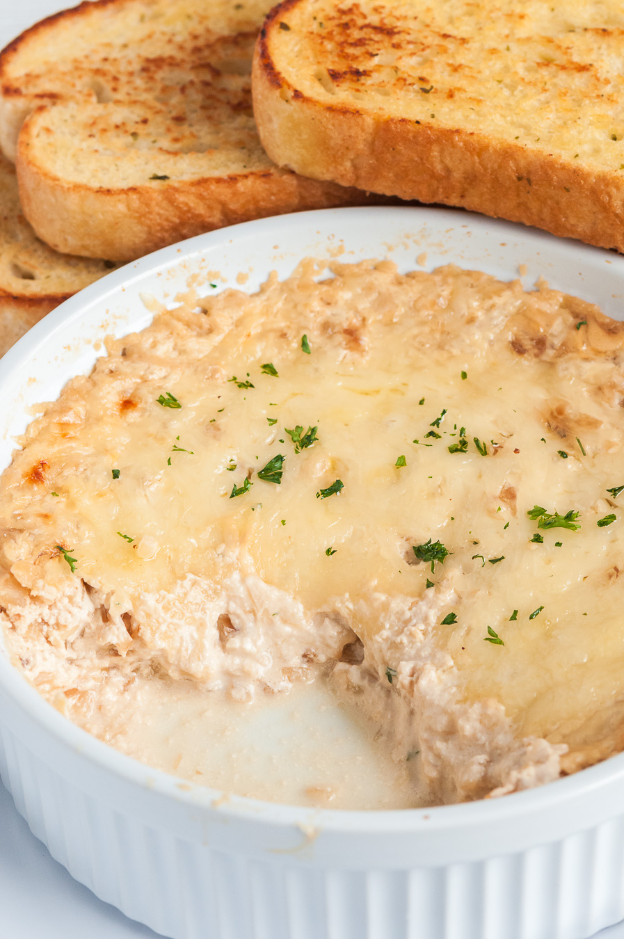 french onion dip in a dish being served 