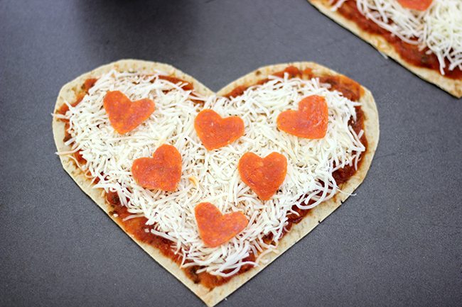 Make your sweetie smile with this super easy heart shaped pizza flatbread with the cutest heart shaped pepperoni. 