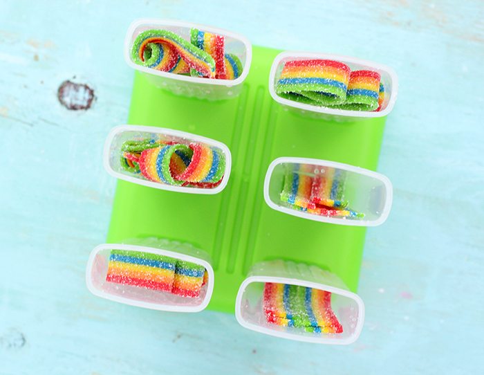 Rainbow Popsicles. These taste SO good! So easy to make too. Just use Airheads Rainbow Candy for the cutest ice pop popsicles ever! 