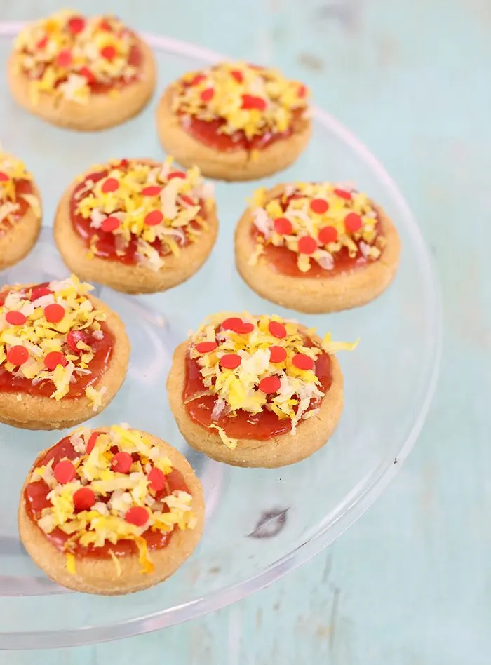 Pizza Cookies! This pizza cookie recipe is so easy using store bought cookies, jam, coconut. Not only are they adorable, but they are delicious too. Perfect for Teenage Mutant Ninja Turtle Themed Parties!