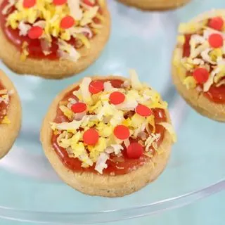 Pizza Cookies! This pizza cookie recipe is so easy using store bought cookies, jam, coconut. Not only are they adorable, but they are delicious too. Perfect for Teenage Mutant Ninja Turtle Themed Parties!