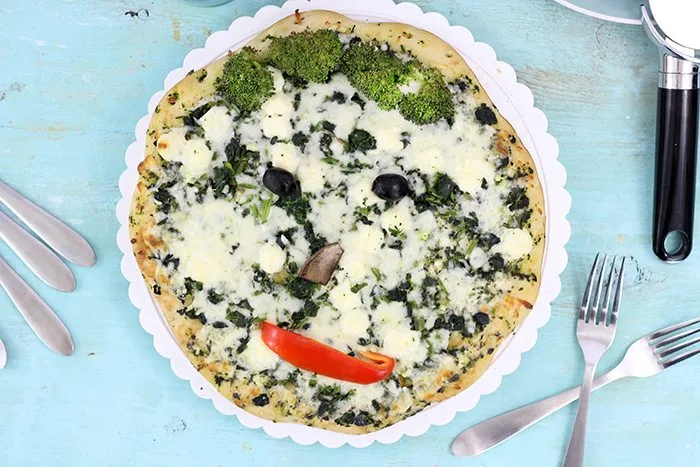 Smiley Face Veggie Pizza. Get your family smiling with these cute veggie emoticon pizza faces. From peppers. mushrooms, olives and broccoli you can get fun in the kitchen.