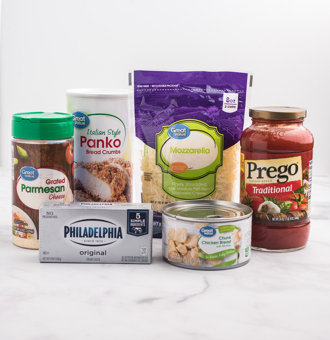 ingredients needed to make the best chicken parmesan dip. Pasta  Sauce Jar, Canned Chicken, Brick of Cream Cheese, Bag of Shredded Cheese, container of panko crumbs and grated parmesan cheese