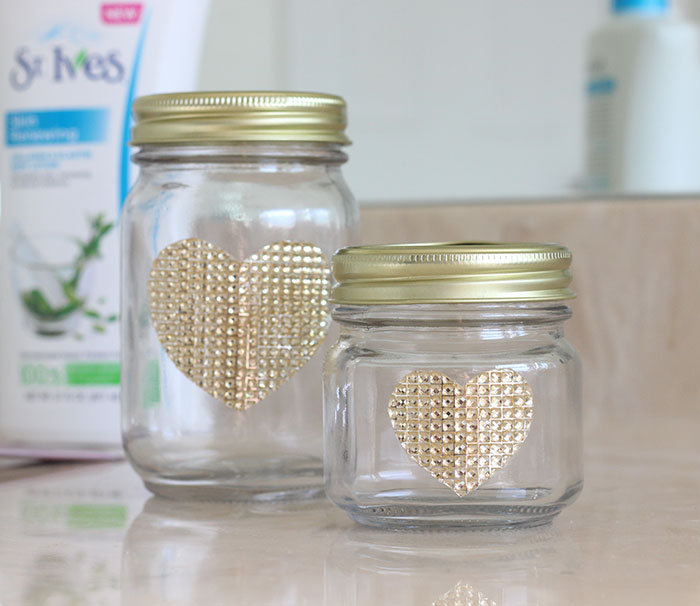 Jar DIY Makeup Organizers with pretty gold rhinestone heart designs.