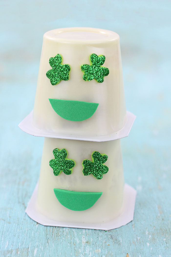 Shamrock Emoji Pudding Cups. Super cute craft idea to celebrate St. Patrick's Day.