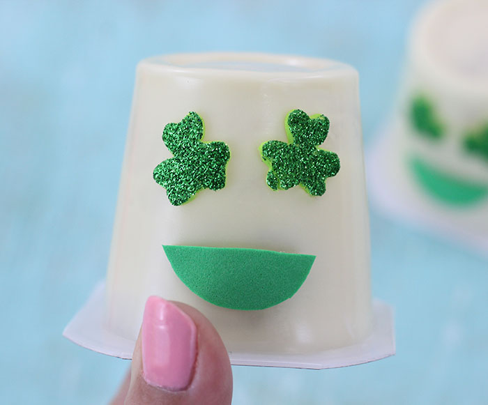 Shamrock Emoji Pudding Cups. Super cute craft idea to celebrate St. Patrick's Day.