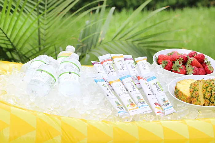 Hydration station for summer. See how to set up an easy cooler in a float and how to stock your station with hydrating food and drinks. Froozer is the perfect frozen snack to cool off with.