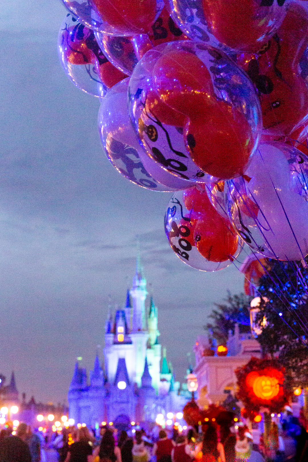 mickey's not so scary party night photo down main street with halloween balloons