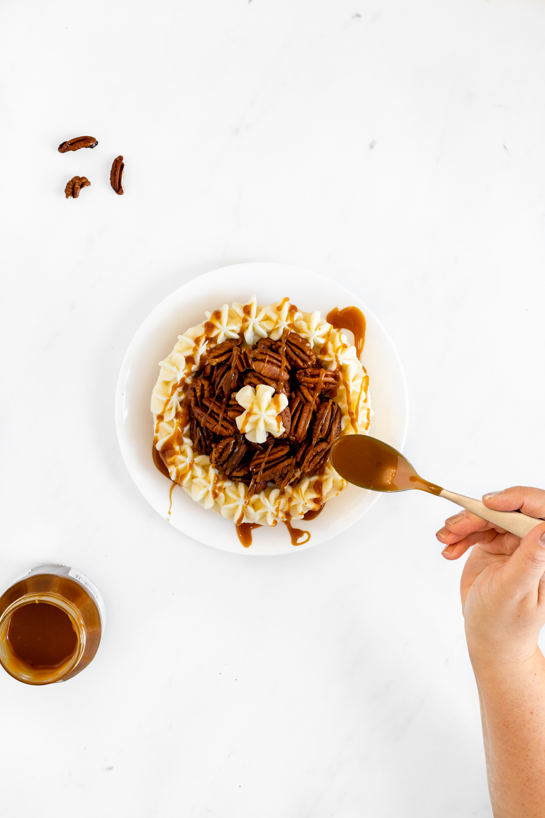 Caramel being drizzled on top of cheesecake