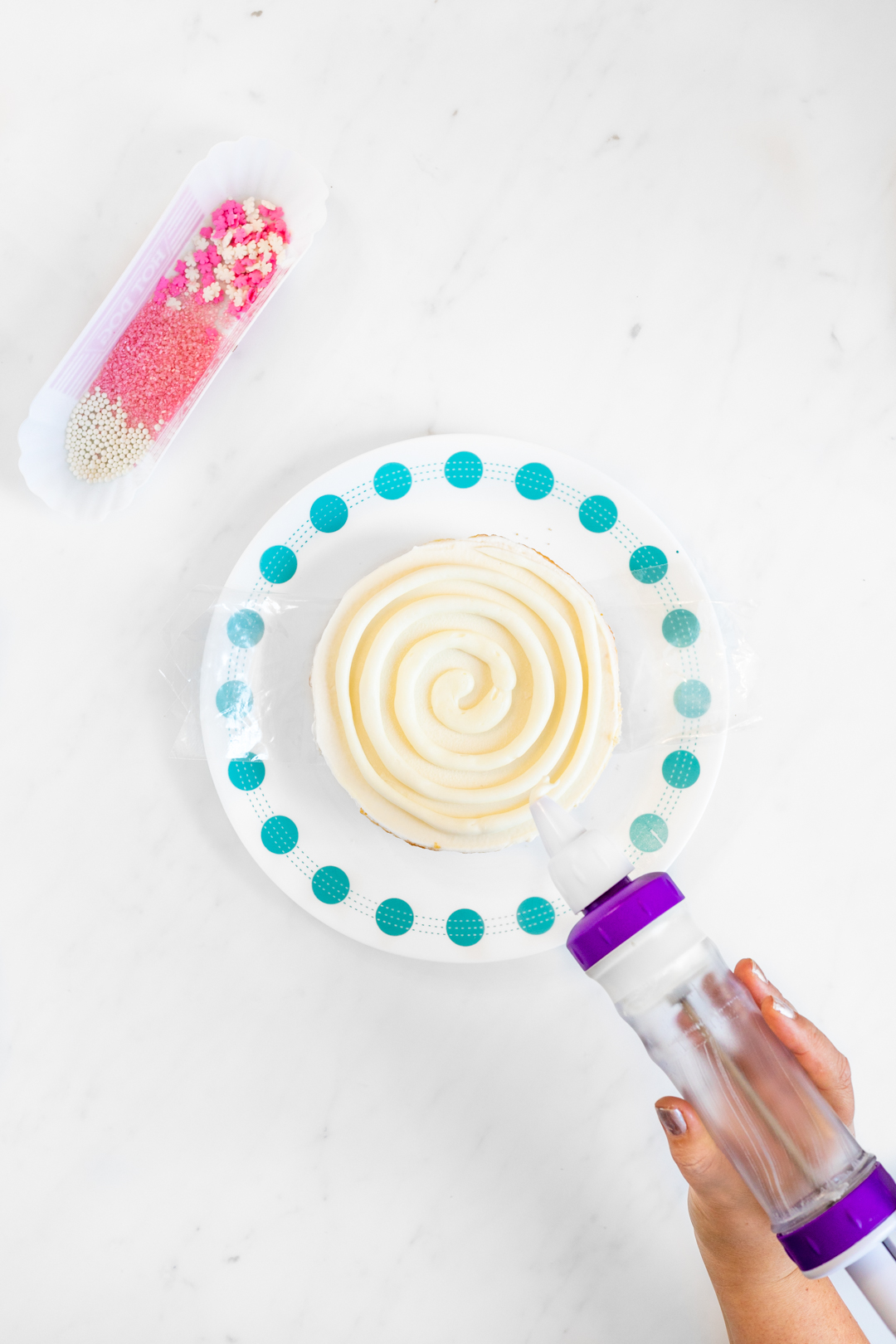 Frosting being swirled on a cake to look like a piece of candy.