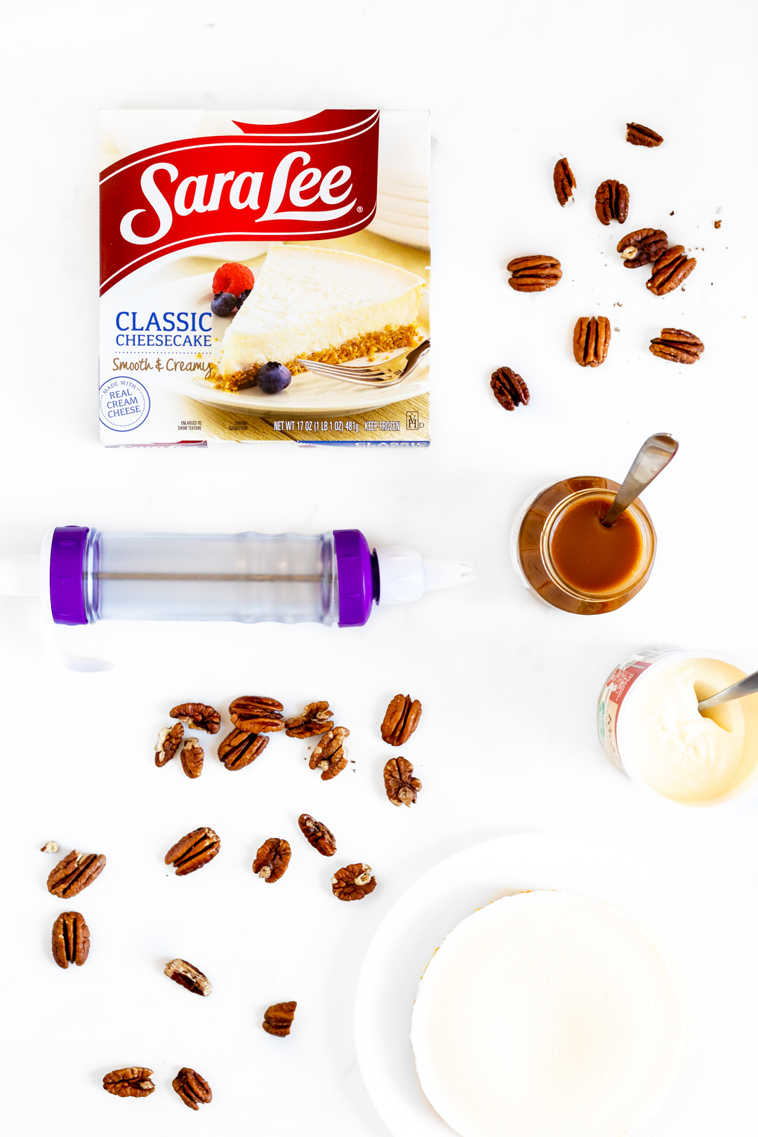 Easy cheesecake ingredients. Pecans. Caramel. Cream Cheese Frosting.