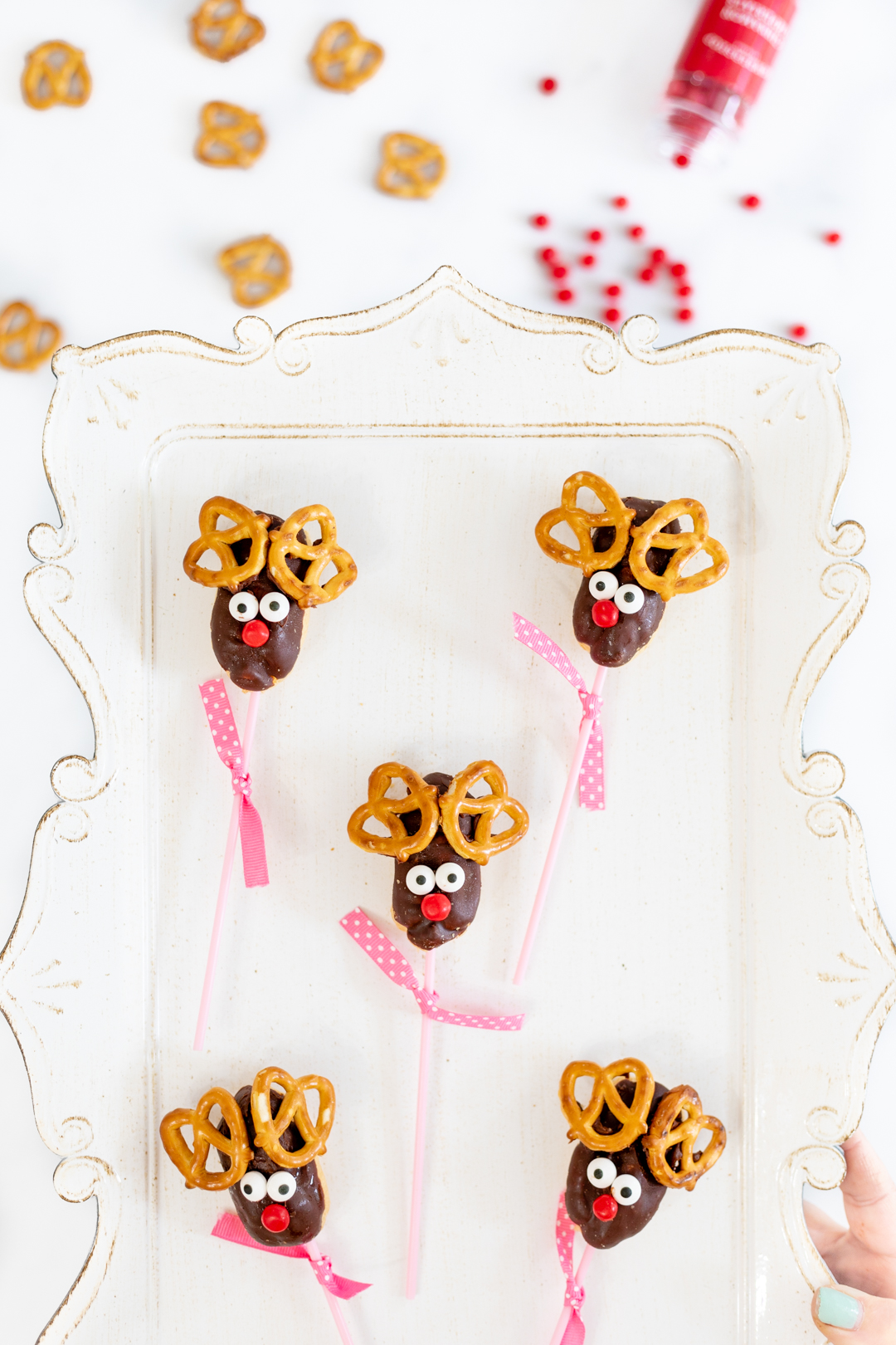 Reindeer lollipops on a tray.