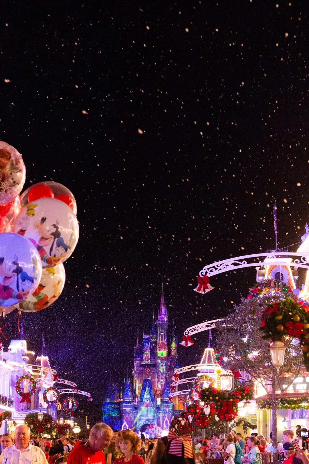 Disney Christmas Balloons on a snowy Main Street
