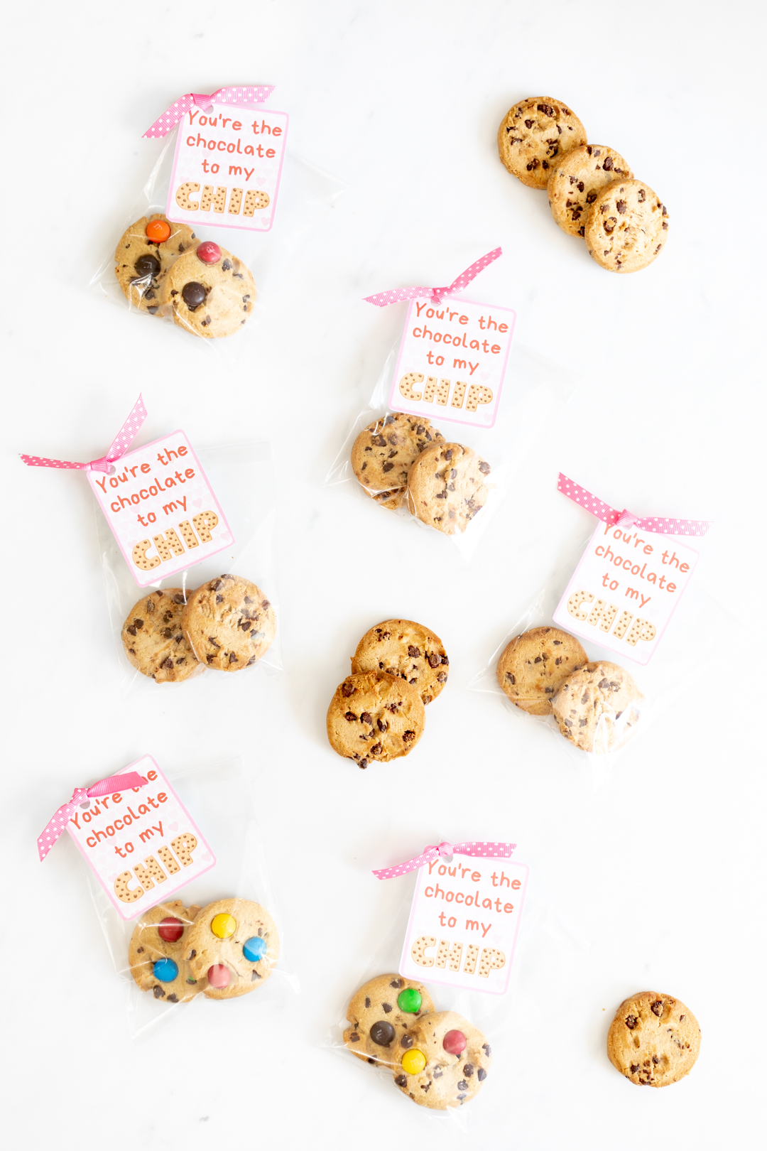 Printable Valentine Cards spread out with ribbons and more cookies