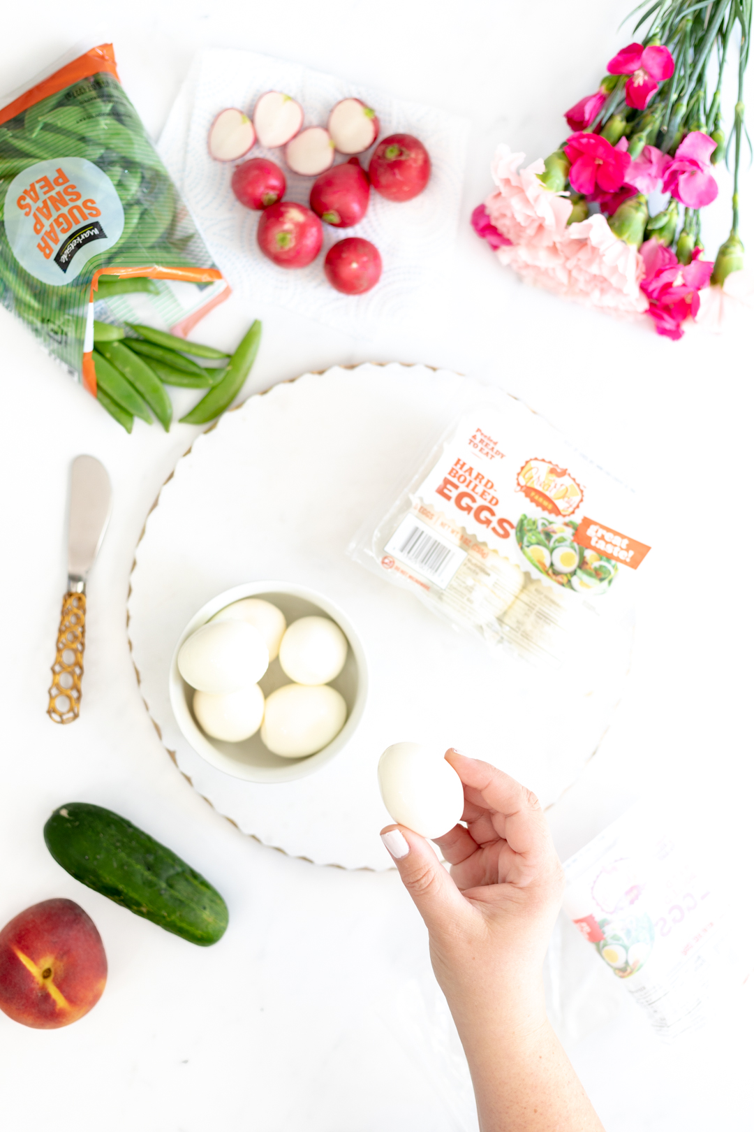 Boiled eggs, snap peas, mini cucumbers and radishes