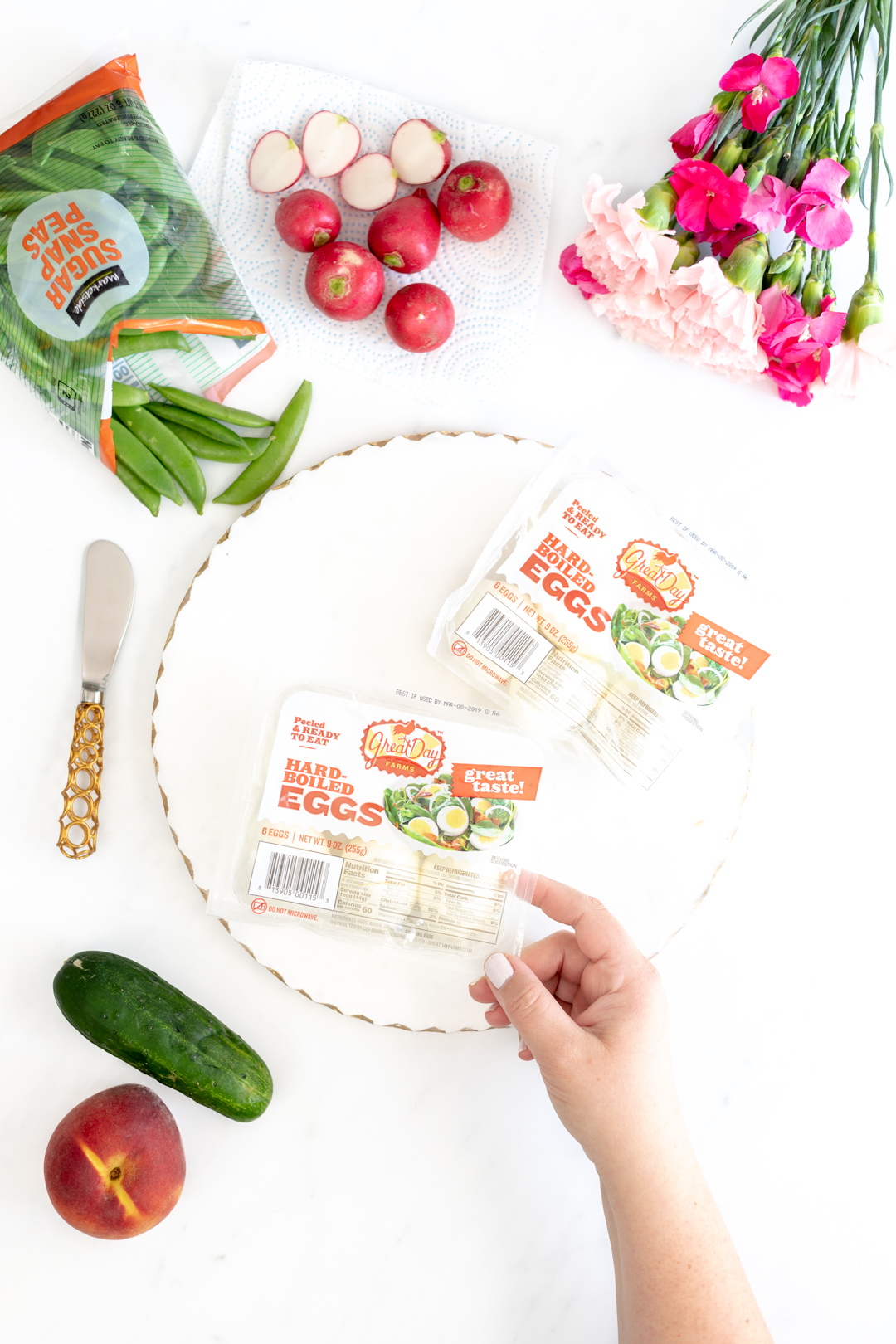 Store bought boiled eggs and vegetable spread with flowers.