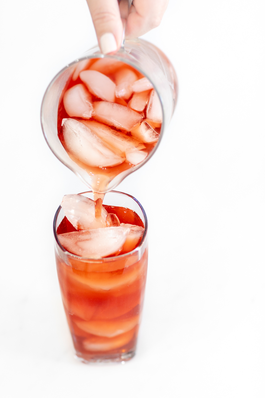 cherry iced tea poured into a glass