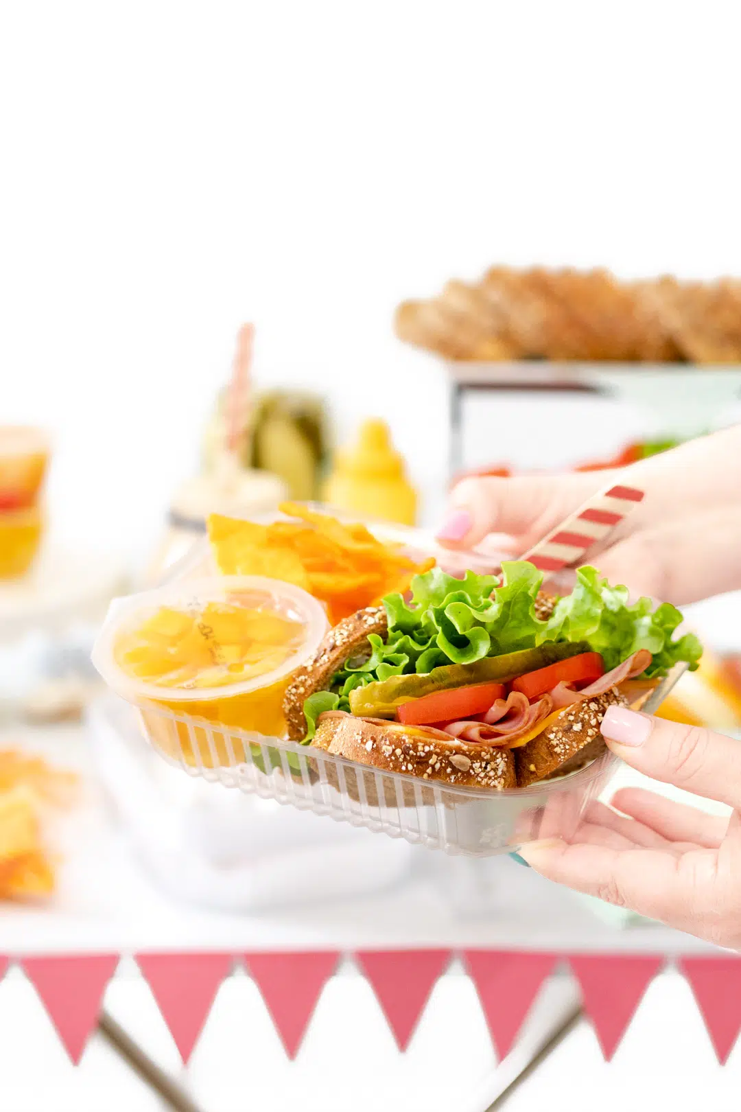 Sandwich buffet fixings with sandwich, fruit and sides.