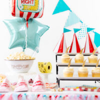Carnival party table with cupcakes, balloons, popcorn and peanuts