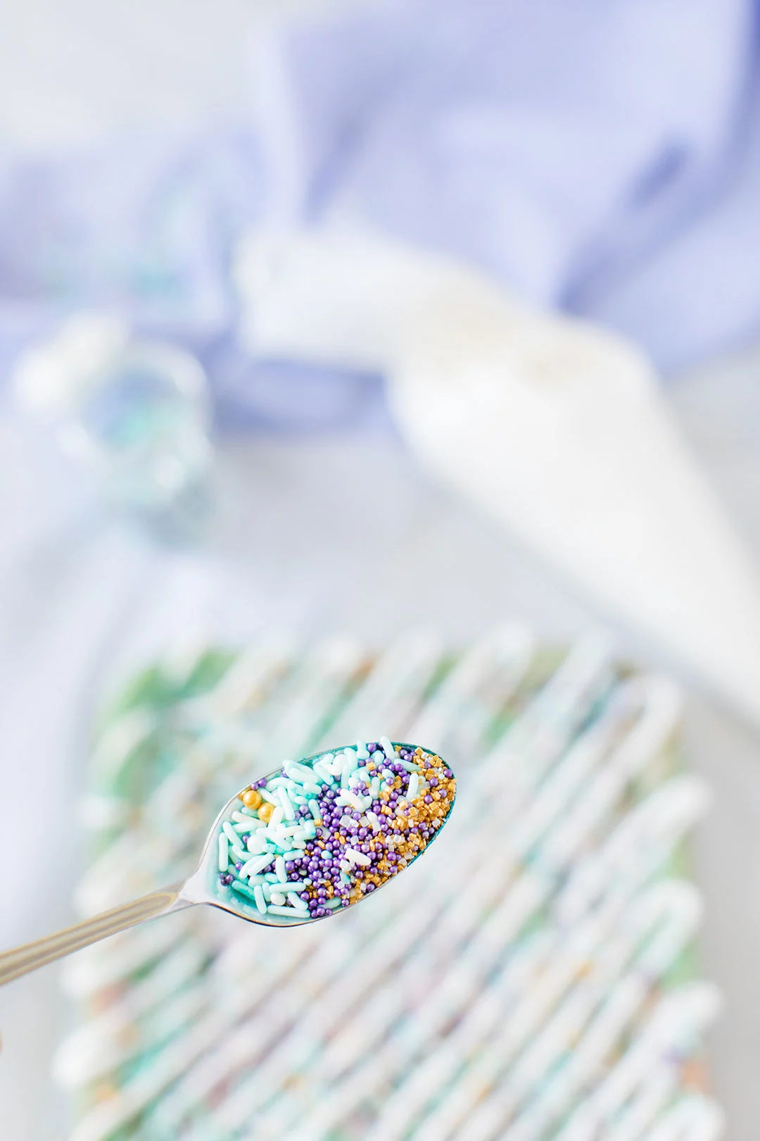 pastel colored sprinkles in a spoon