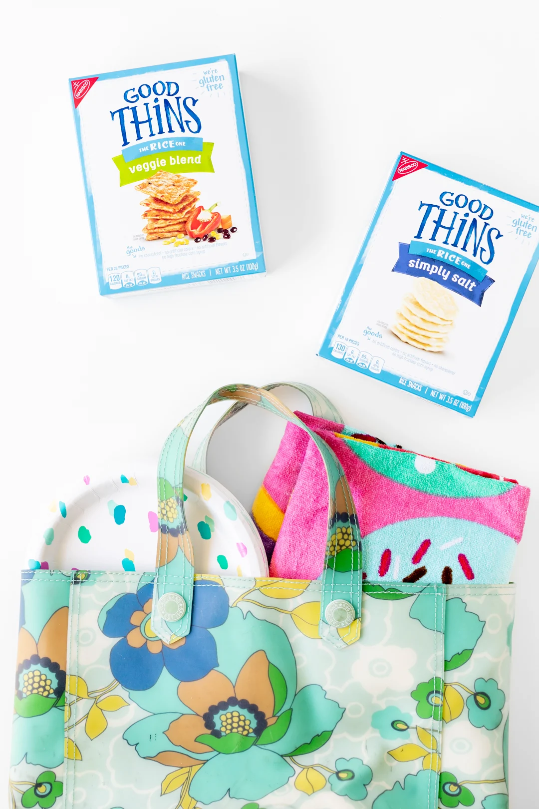 beach bag with towel, plates and crackers