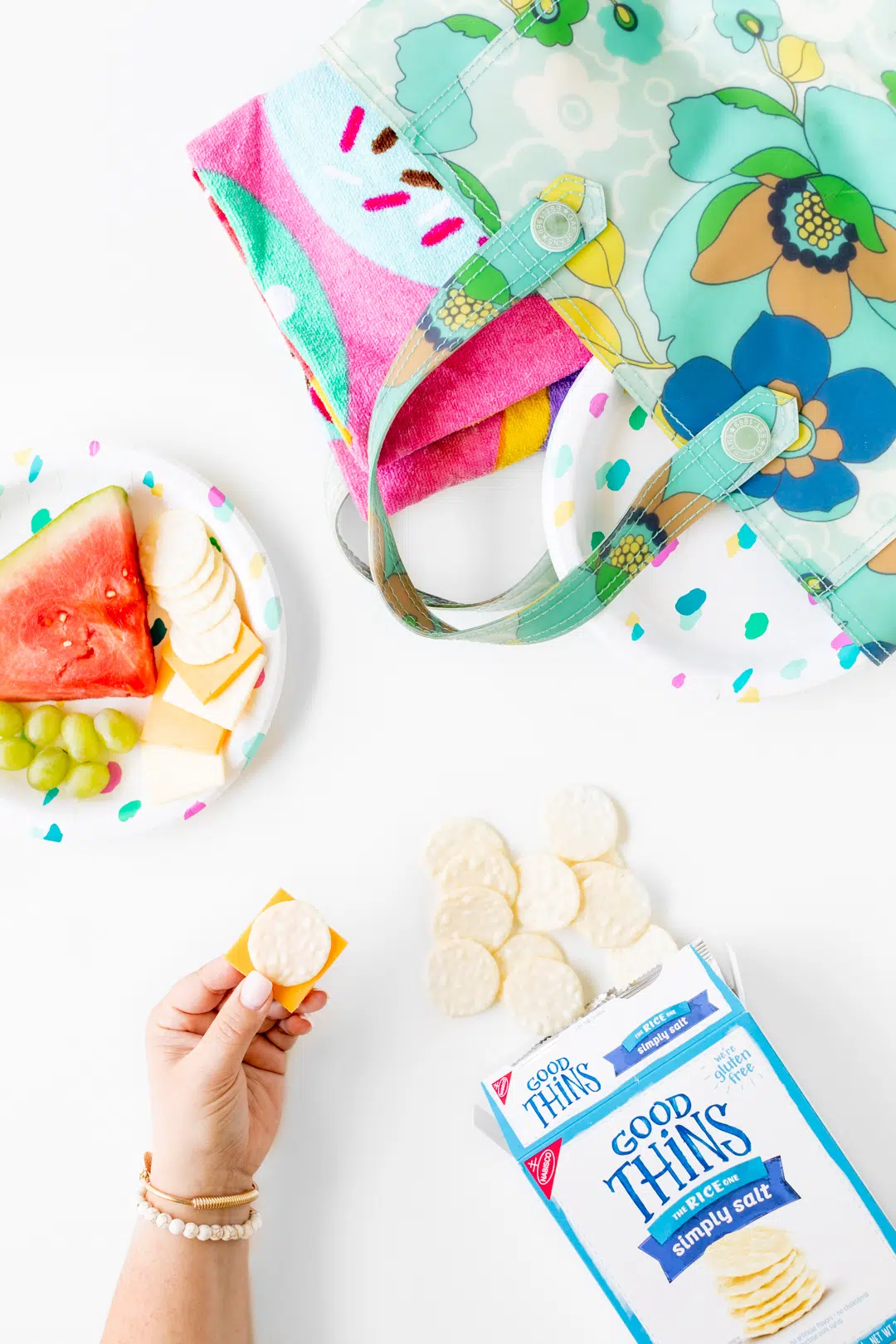 rice crackers, fruit on a plate with beach bag