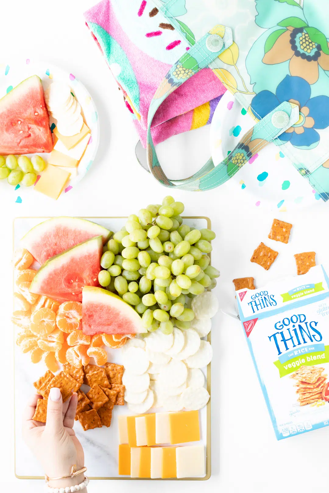 fruit and cheese snack board with grapes, watermelon, mandarin oranges and cheese